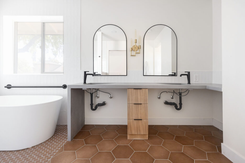 Barrier free bathroom with roll under sink, concrete countertops, and terracotta hexagon tile floors.