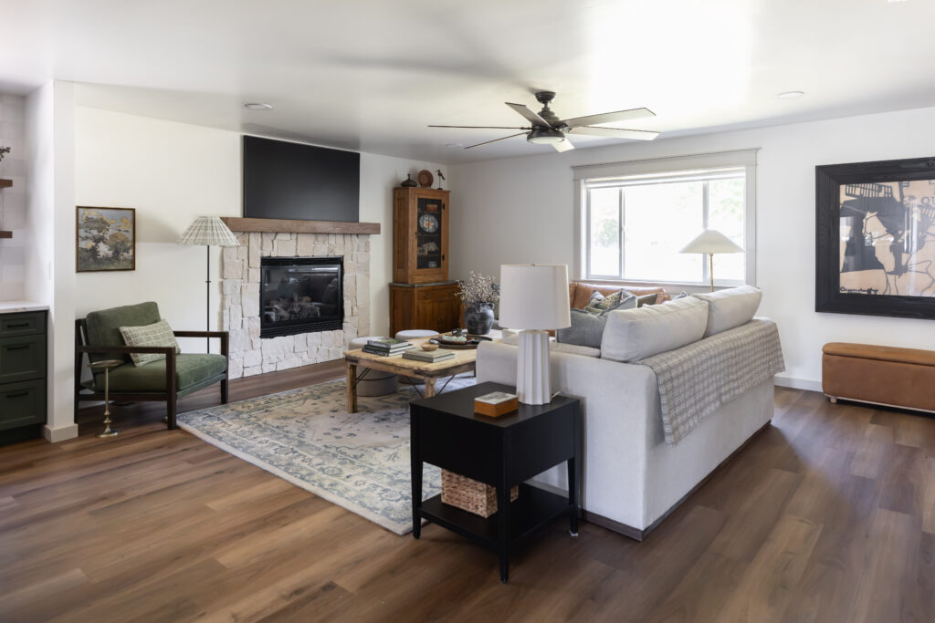 Bright, open concept living room in a forever home with wide circulation paths, low pile area rug, barrier free furniture layout, and seamless flooring transitions designed for accessibility, comfort, and everyday living.